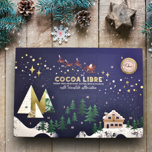 Vegan Advent Calendar. A night sky graphic print over a christmas themed dairy free advent calendar box.